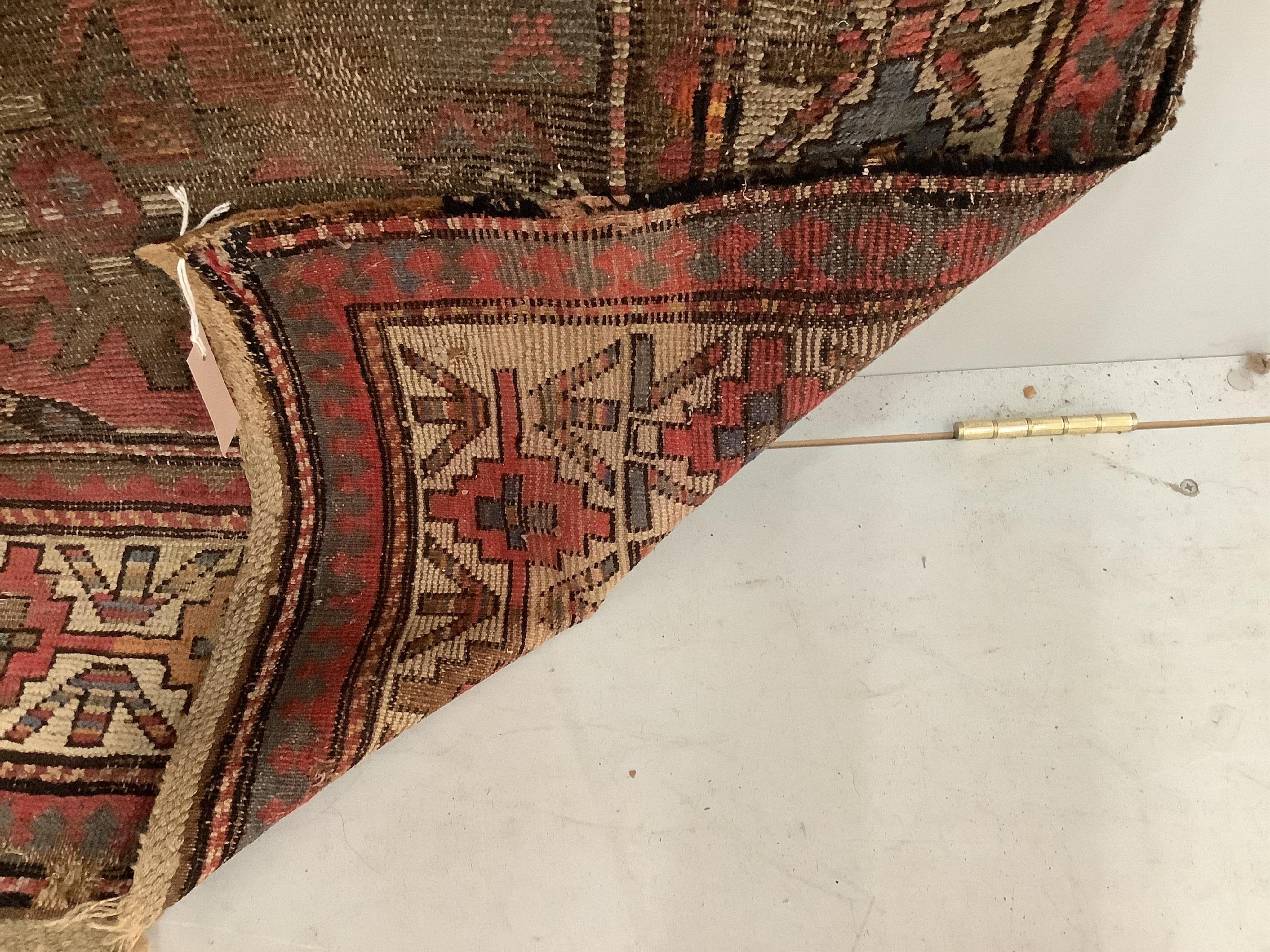 An antique Caucasian geometric rug, 250 x 140cm, together with a Belouch prayer rug, 130 x 78cm. Condition - poor